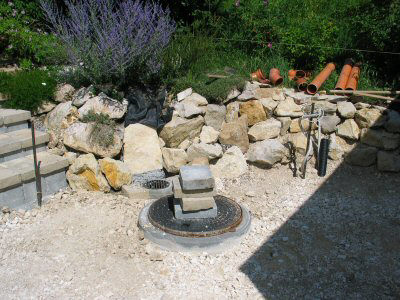 Mauer zum Nachbarn, Zisterne mit Kanaldeckel